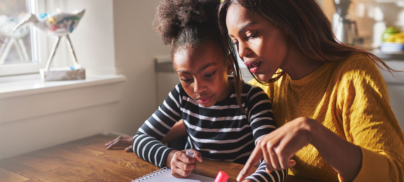 Mom helping daughter with homework